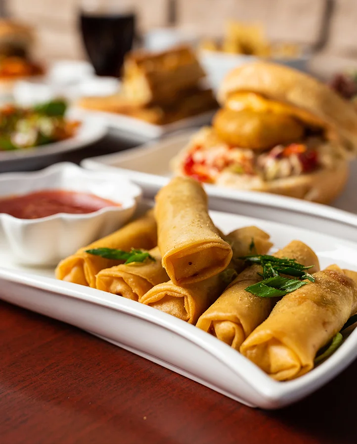 Sector 17 Indian Eatery signature dishes - Aloo Tikki Noodle Burger and Indian street food in Sage Hill Calgary