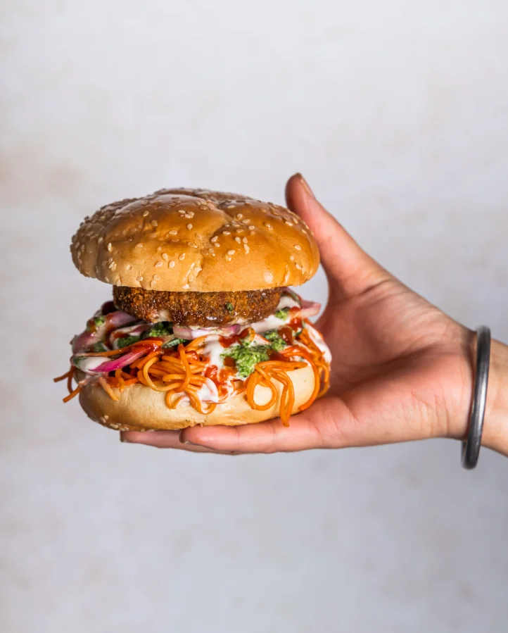 Aloo Tikki Noodle Burger - Signature Desi Burger at Sector 17 Sage Hill Calgary